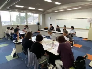 田彦地区民生委員児童委員協議会で歳末たすけあい支援事業を説明する様子